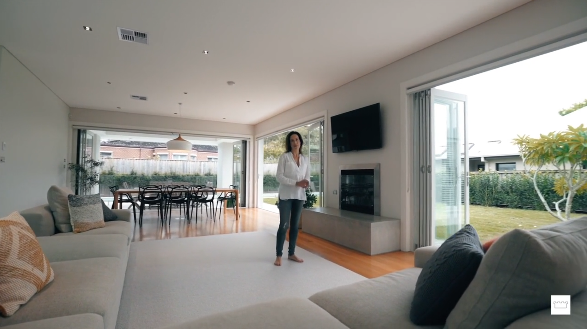 Woman standing in middle of light and bright living area