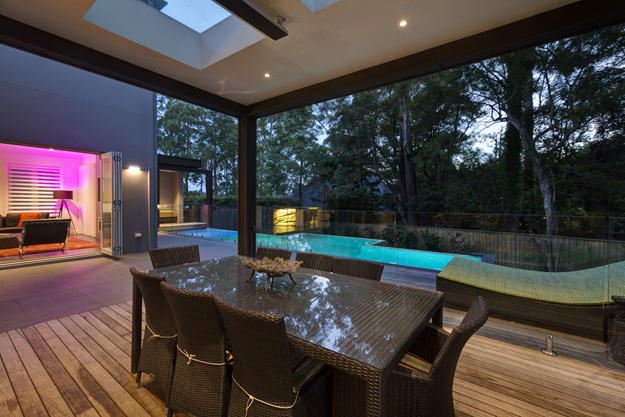 Heating lamp outdoors with pool at the back