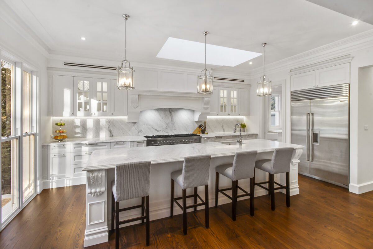 Kitchen in French Contemporary style. Features marble, glass and crisp white finishes, creating a sense of grand intimacy