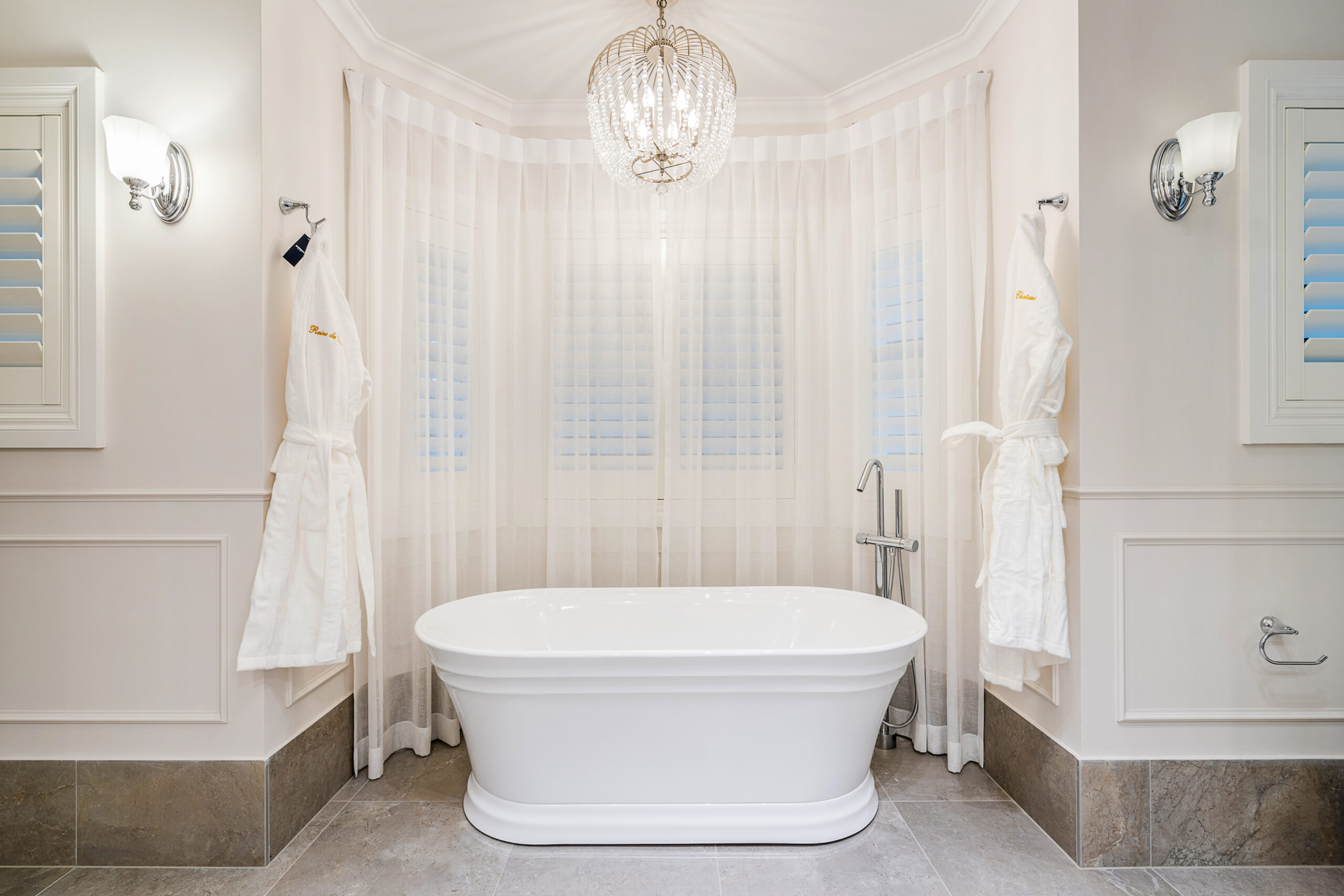 Freestanding tub in an alcove with sheer curtains