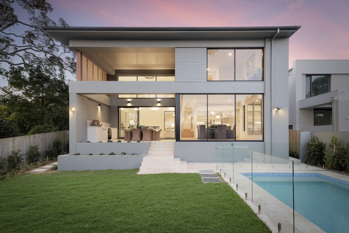Greenwich Contemporary: backyard and house at dusk
