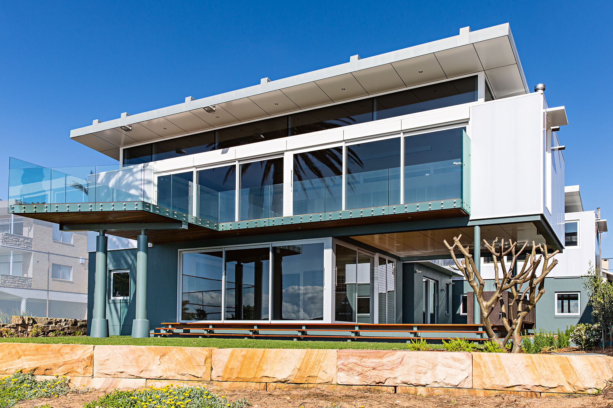 Collaroy Modern Beach: house exterior with sandstone landscaping