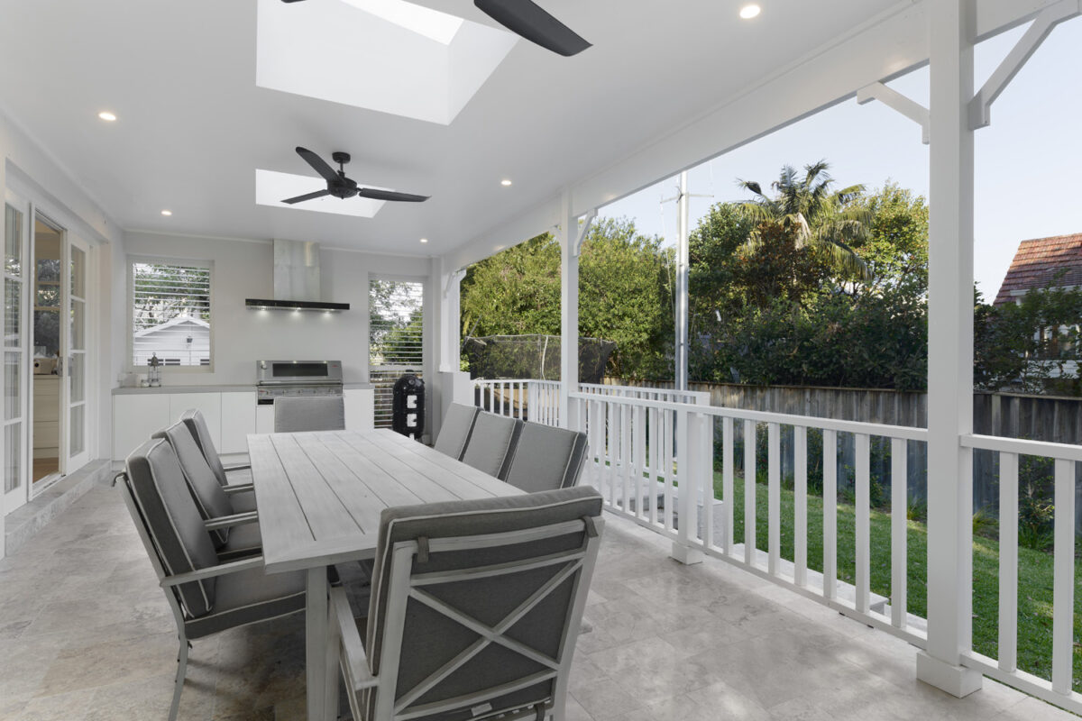 Greenwich Traditional Hamptons: Outdoor porch with outdoor kitchen overlooking green backyard