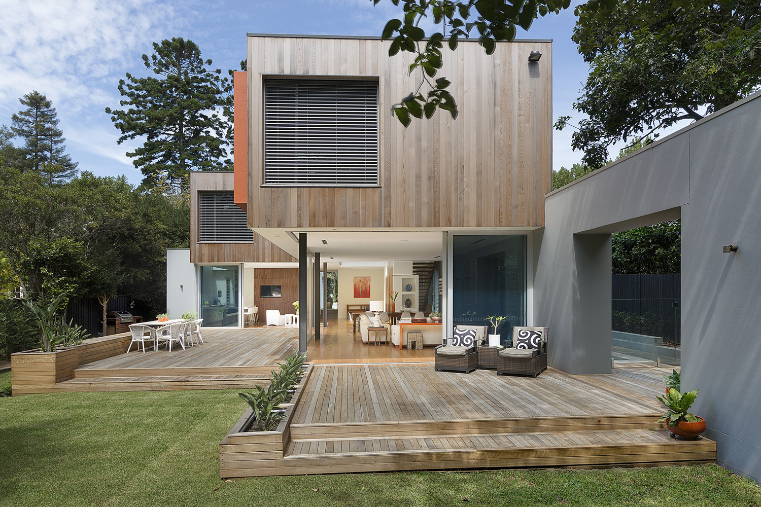 Wahroonga Modern: cedar-clad design with decks flowing out onto green lawn