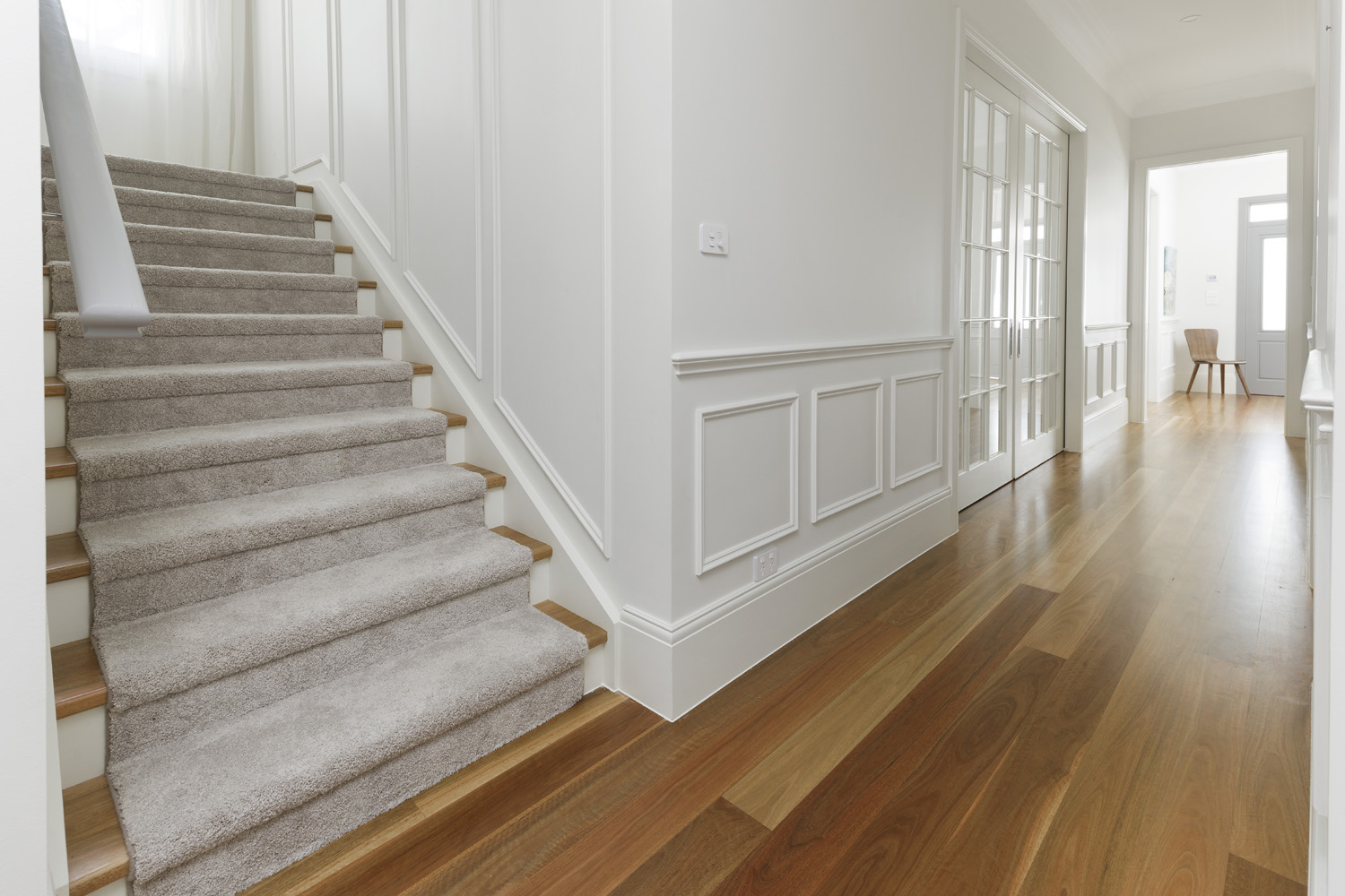 Greenwich Traditional Hamptons: wainscotting along corridor with satin wooden floors