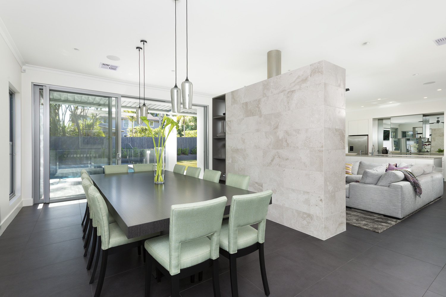 St Ives Contemporary Ranch: Dining area separated from living by stone fireplace