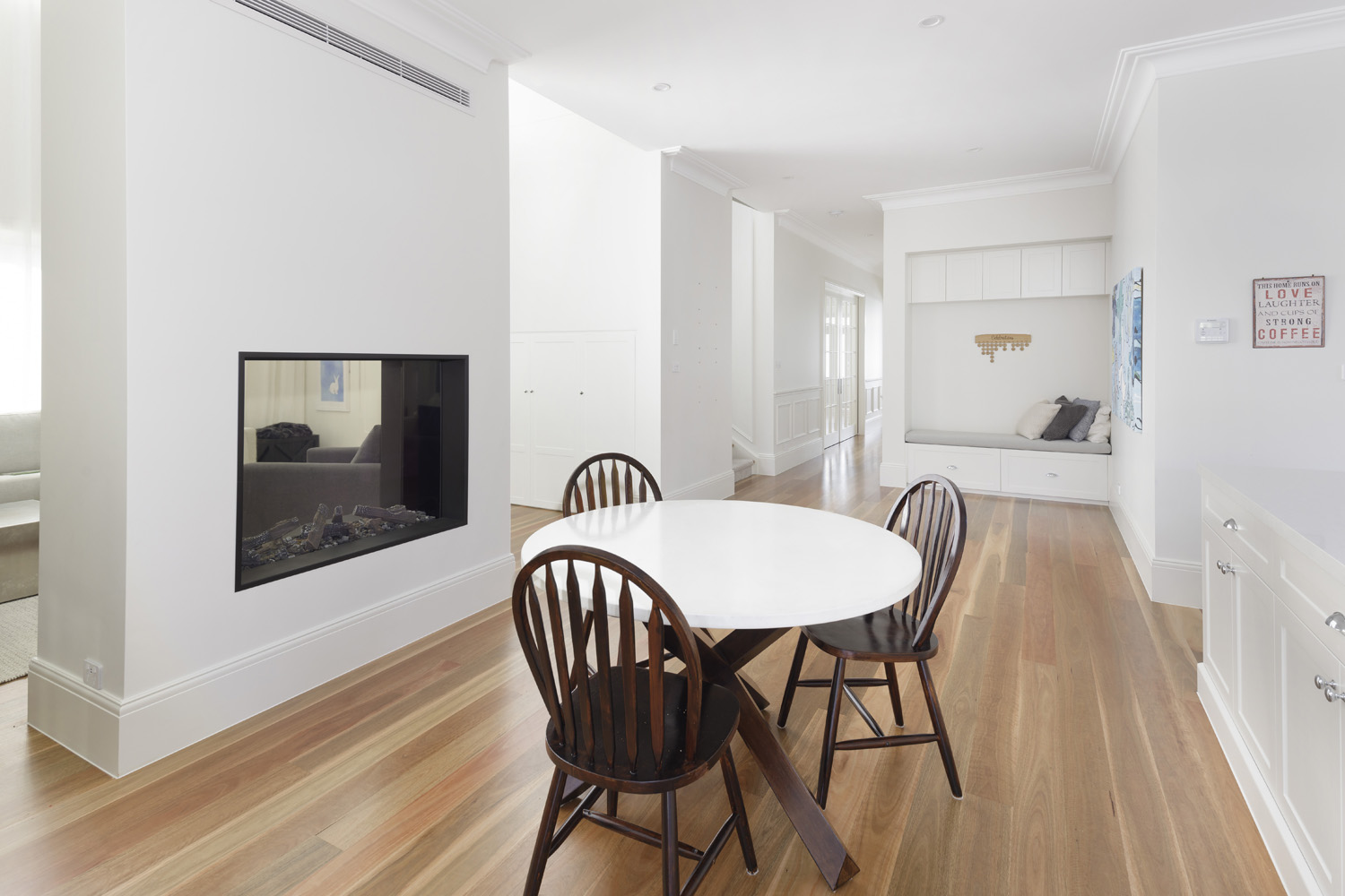 Greenwich Traditional Hamptons: casual dining area with fireplace and bench seating
