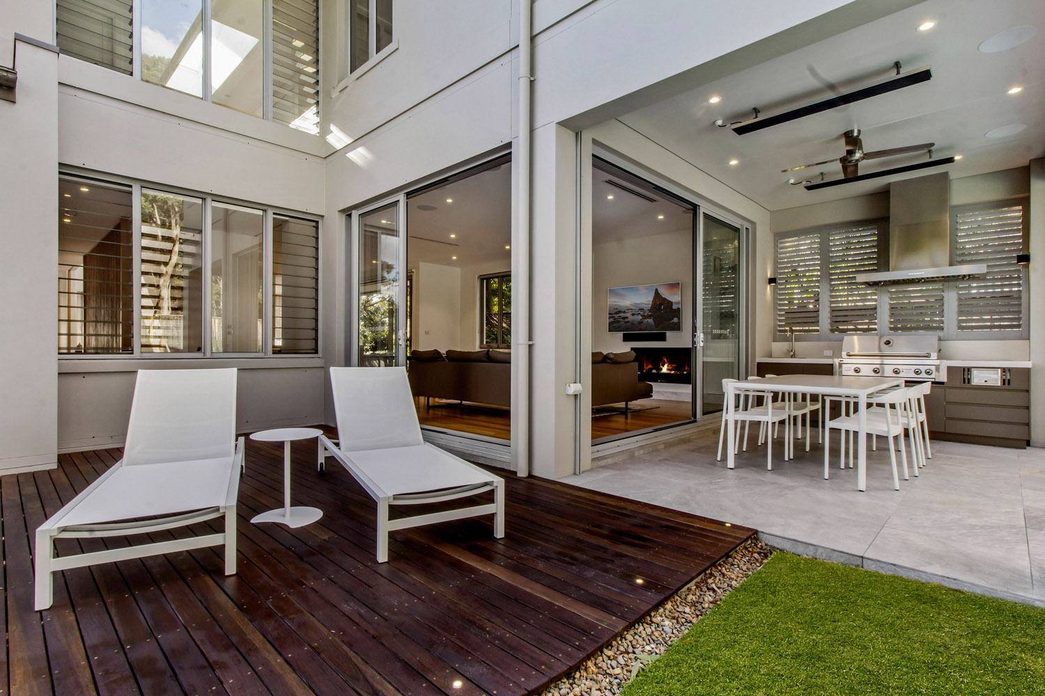 Killara Contemporary: outdoor lounging/sunbathing timber deck, leading to outdoor kitchen and dining