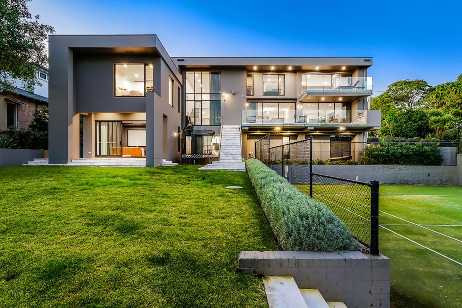 Northbridge Ultra Modern: view of house from backyard with tennis court