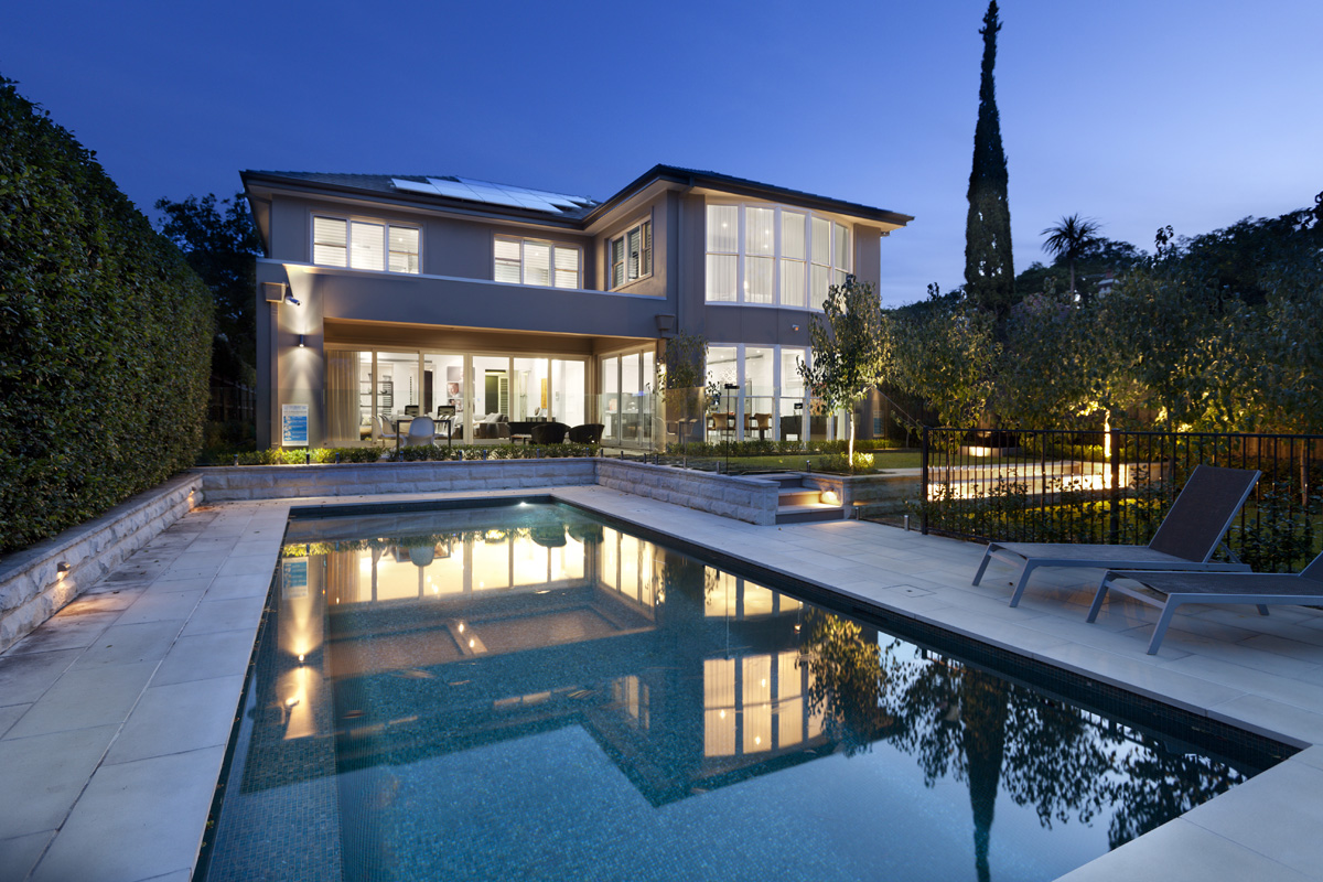 Hunters Hill Modern Traditional: Pool and backyard lit up at night