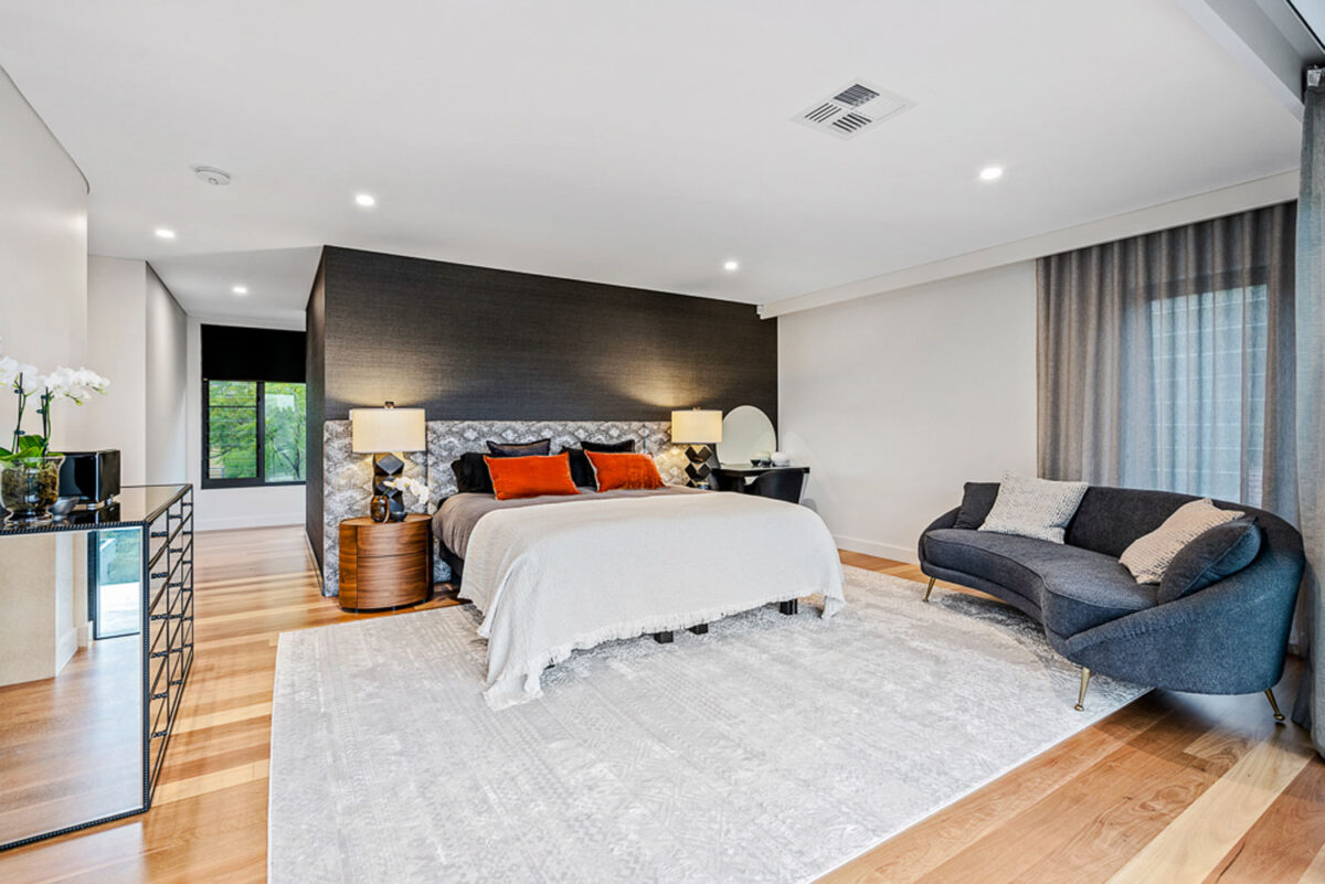 Northbridge Ultra Modern: expansive bedroom with seating area and walk ins