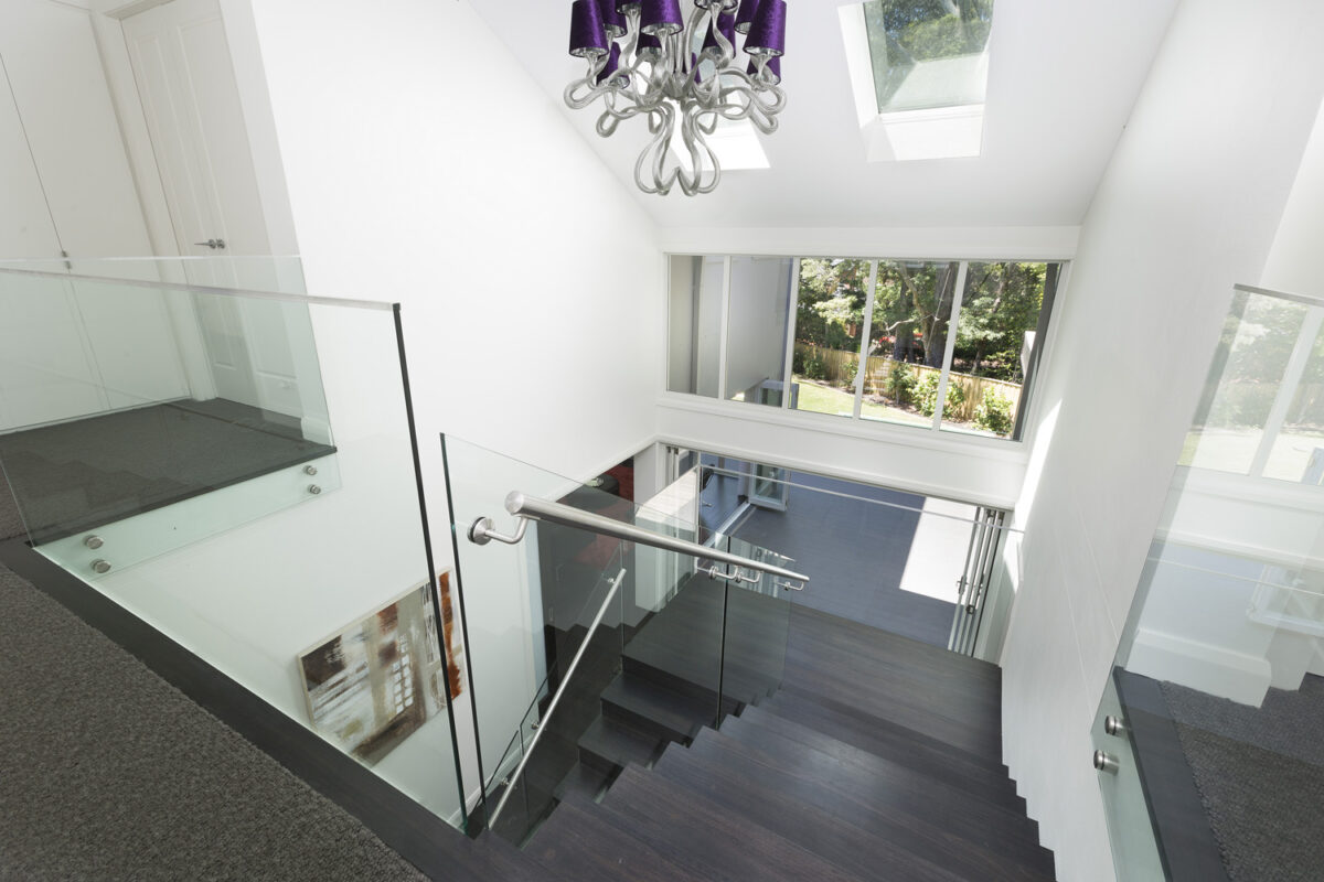Warrawee Neo-Georgian: staircase with dark treads and glass railing