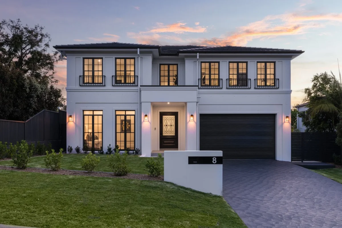Classical Luxury with two-storey residence in Castle Hill with black-framed windows, landscaped garden and driveway at dusk