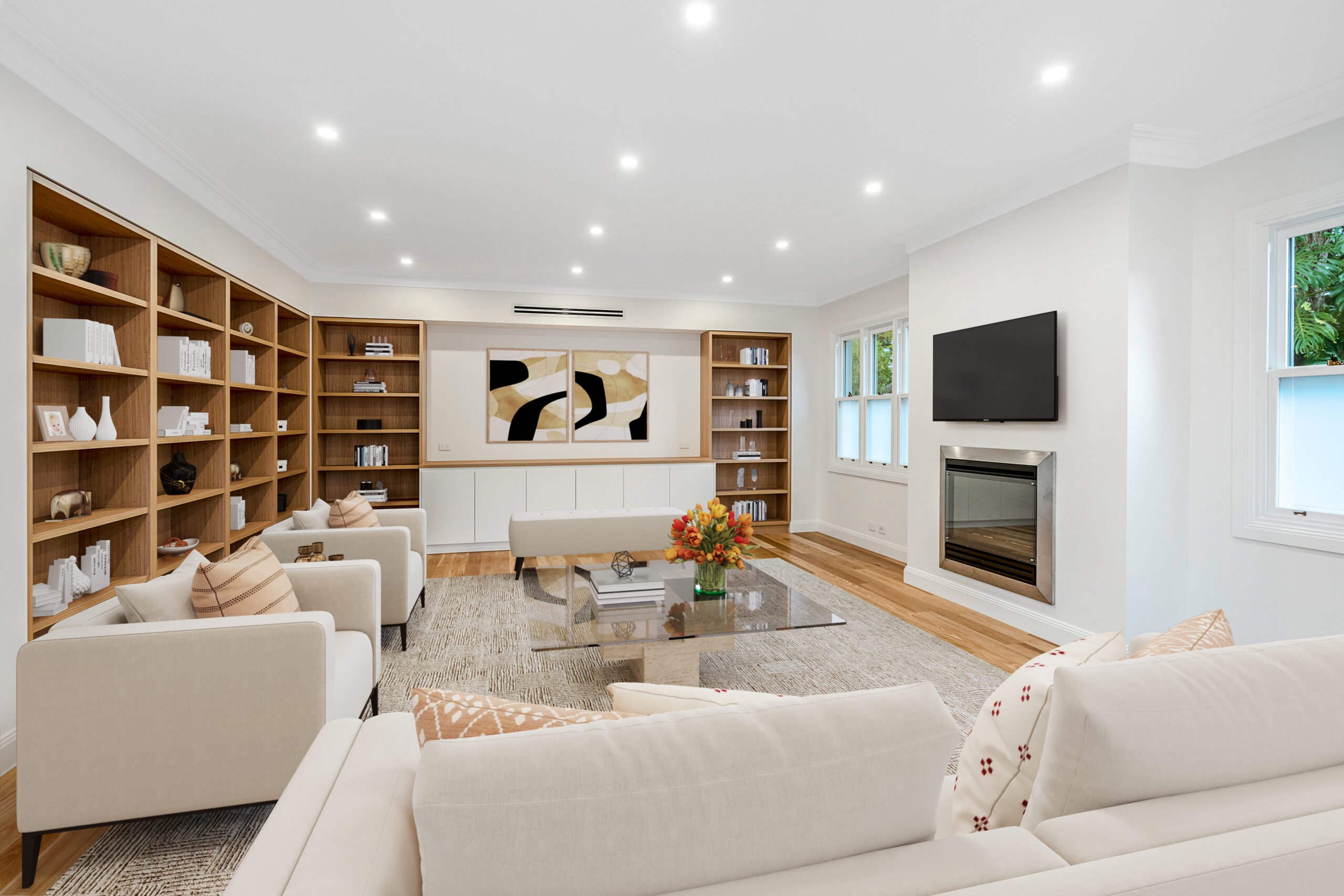 Refined living room with bespoke timber shelving, a fireplace and elegant neutral furnishings.