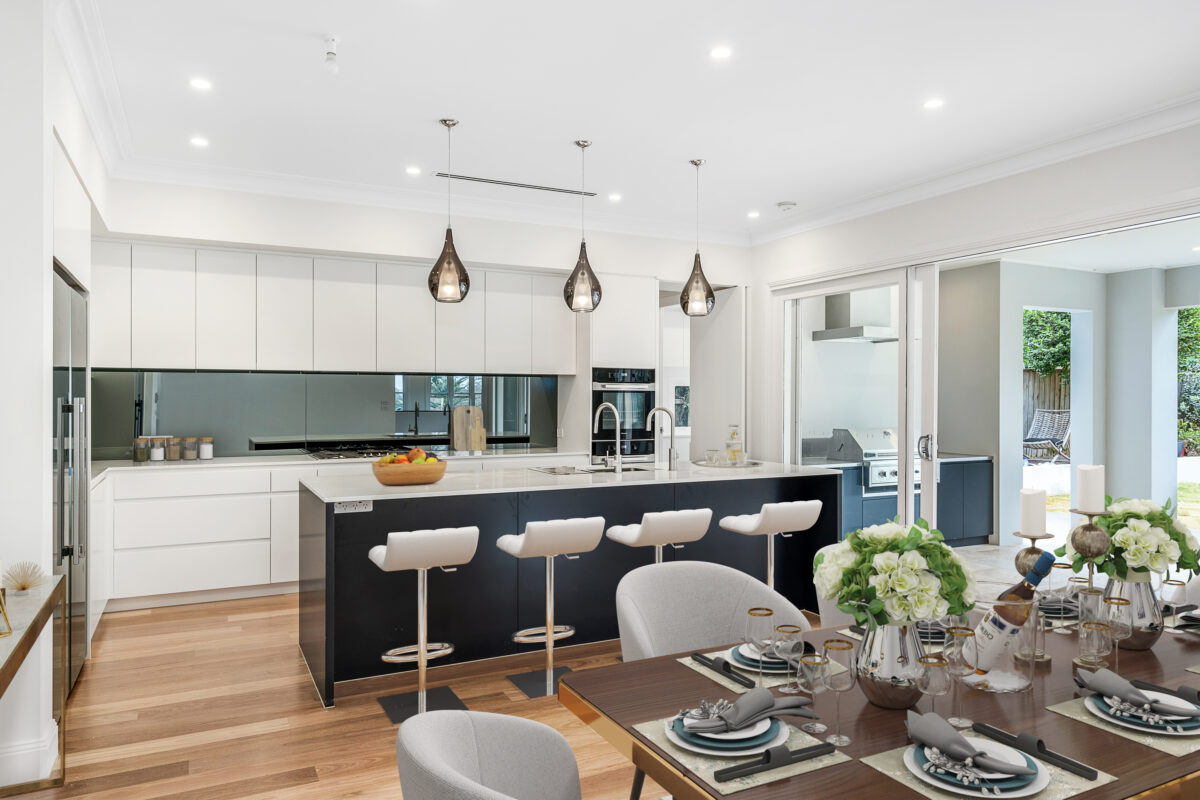 Open-plan kitchen and dining area with island seating and a seamless alfresco connection.